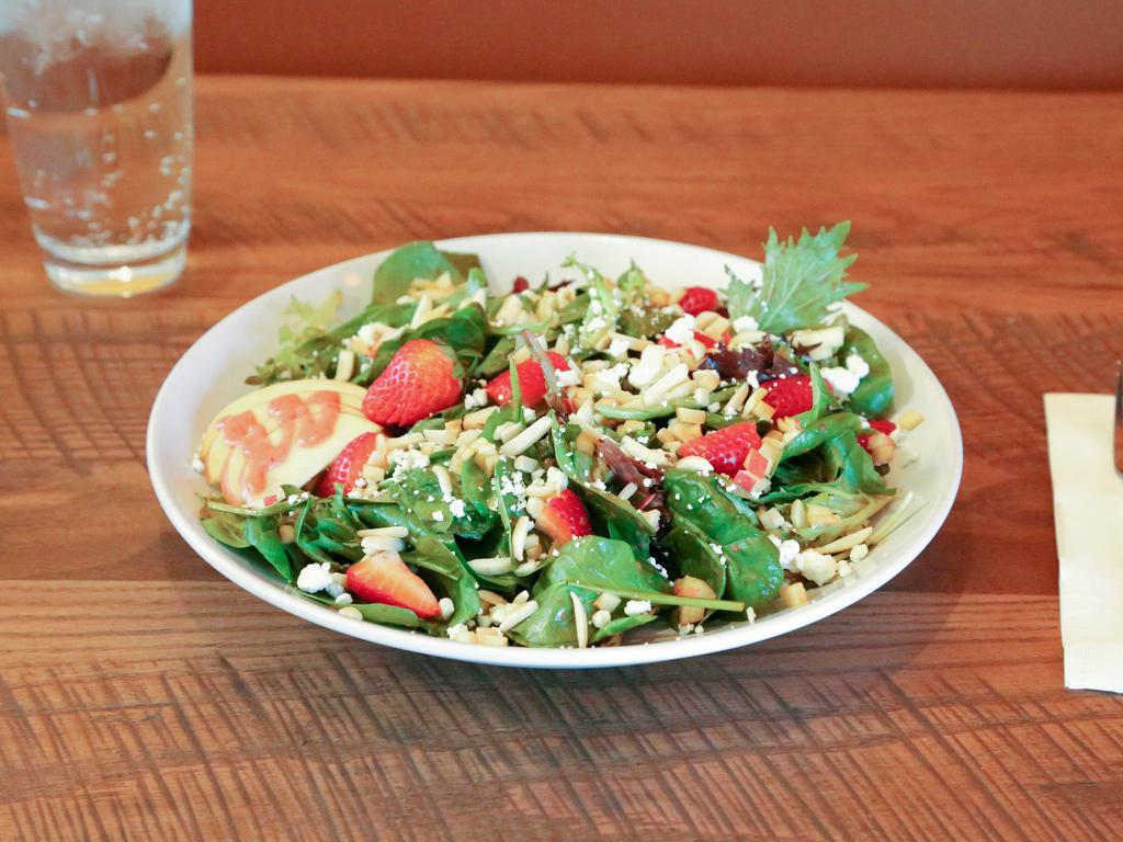 Strawberry Tamarind Salad · Spring mix topped with fresh strawberries, crisp apple slices, goat cheese and almonds all tossed in a homemade strawberry tamarind vinaigrette. Add grilled chicken or bacon for an additional charge.