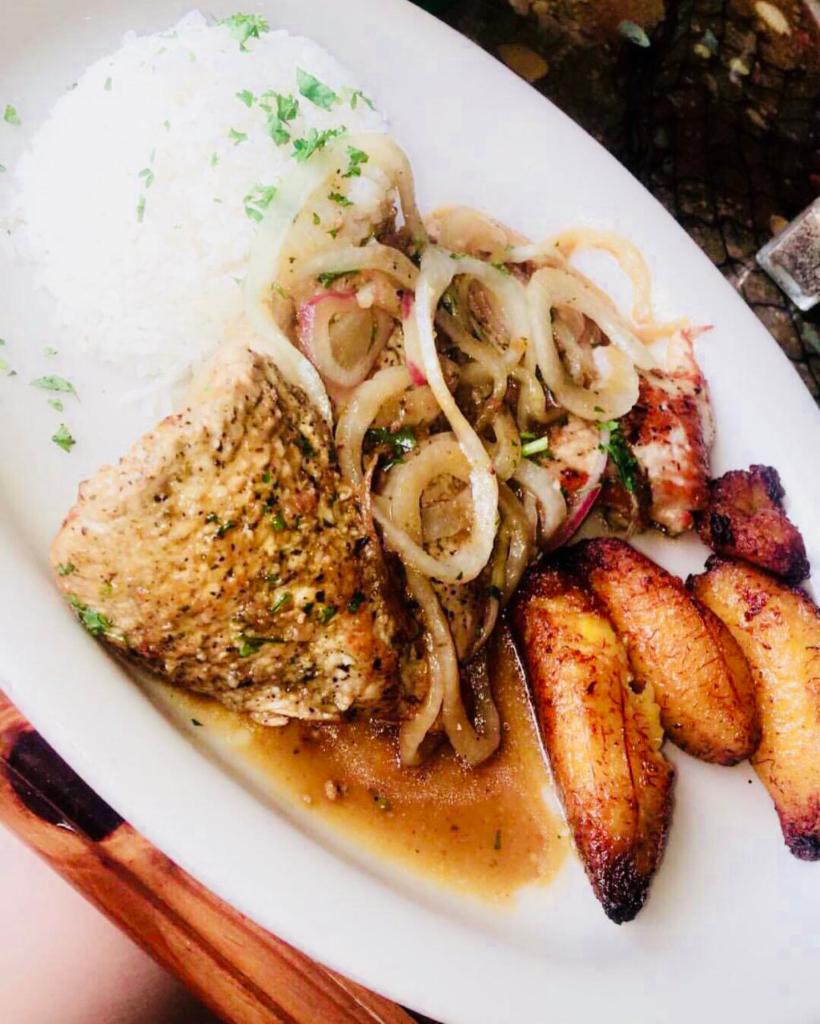 Pork Steak · Bistec de cerdo. Sauteed onions, garlic, lime juice, served with yuca, black bean rice, and plantains.