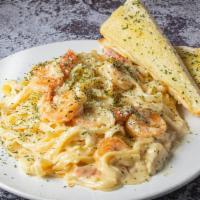 Fettuccini Alfredo with Shrimp · Served with freshly baked garlic bread.