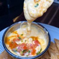 Chef's Queso. · Our fresh made spicy cheese sauce & fresh cut pico de gallo and served with our house made c...