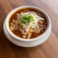 Grass-Fed Beef Chili. · Our grass-fed beef & pinto beans w/ a perfect blend of fresh poblano & chipolte peppers topp...