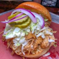 Pulled BBQ Chicken Sandwich.. · Braised & smothered on our original BBQ sauce and topped with onions, coleslaw and pickles.