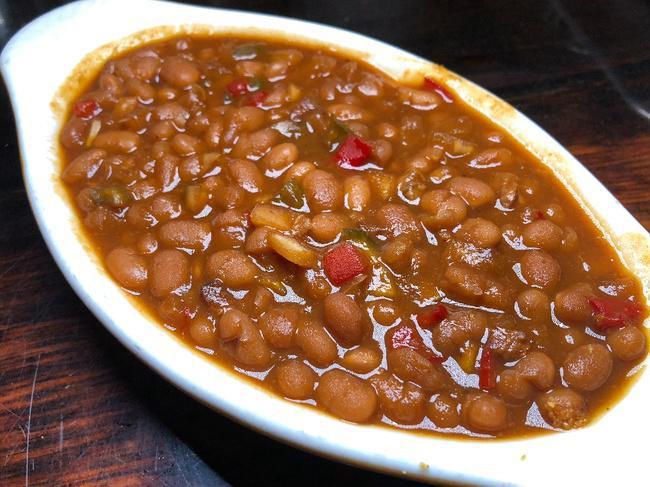Applewood Bacon Baked Beans.. · Slow simmered navy beans with our house made pork chunks.