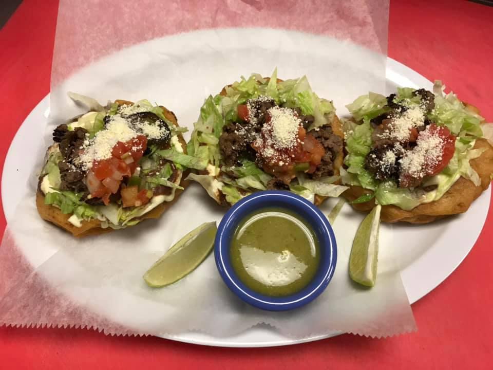 Sope Res · Beef in a fried corn tortilla with refried beans, lettuce, pico de gallo, and cheese.