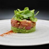 Tuna Tartar · Raw tuna cut into small cubes and served over avocado. Asian flavors of ginger, soy, chili a...