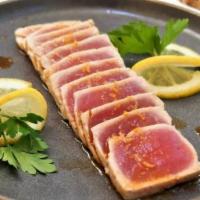 Tuna Tataki - 9 pieces · Yellowfin tuna lightly seared and served rare with a citrus-based soy sauce.