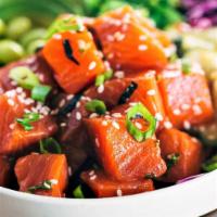 Salmon avocado salad · Fresh raw salmon, avocado, scallions, Kimchi sauce, sesame seeds.