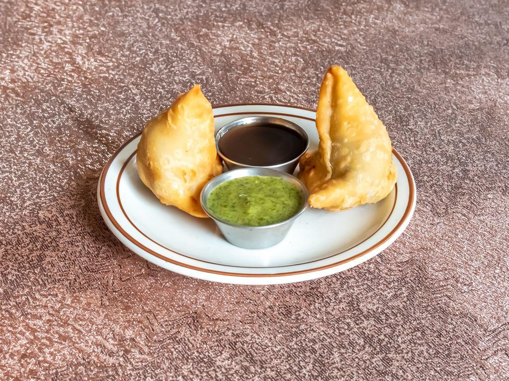 Vegetable Samosa · Crispy turnovers stuffed with mildly spiced potatoes & green peas. Most popular appetizer. Vegan.