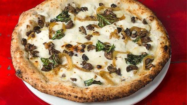 Spacca Napoli Pizza · Fresh mozzarella, Taleggio cheese, mushrooms, caramelized onions, Pecorino Romano, basil, truffle salt, black truffle oil and basil. Vegetarian.