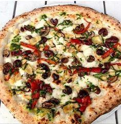 Partenope Pizza · Fresh mozzarella, fresh basil pesto, roasted artichokes, roasted peppers, mushrooms, Gaeta olives and pecorino Romano. Vegetarian.