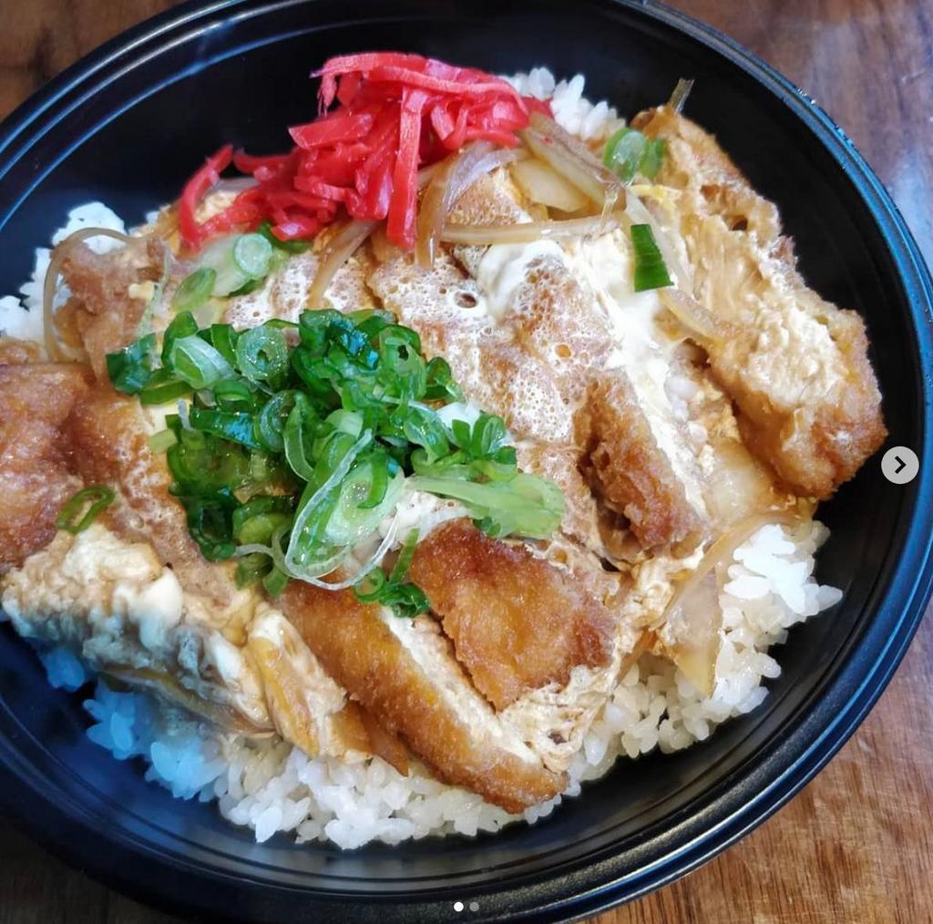 Pork Katsu Don · Pork cutlet cooked with egg and sliced onion in special Japanese sauce. Topped with scallion and pickled red ginger, served with rice.