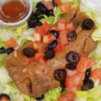  Pastele Supreme · 1 pastele on a bed of lettuce, olives, tomatoes, 1 oz. sour cream, 2 oz. dressing on the side.