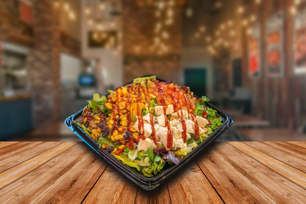 BBQ Chicken Salad · Premium grilled chicken breast, mixed greens crispy cheddar onions, diced tomatoes, corn & black bean mix, chipotle ranch dressing, finished with a drizzle of bbq sauce.