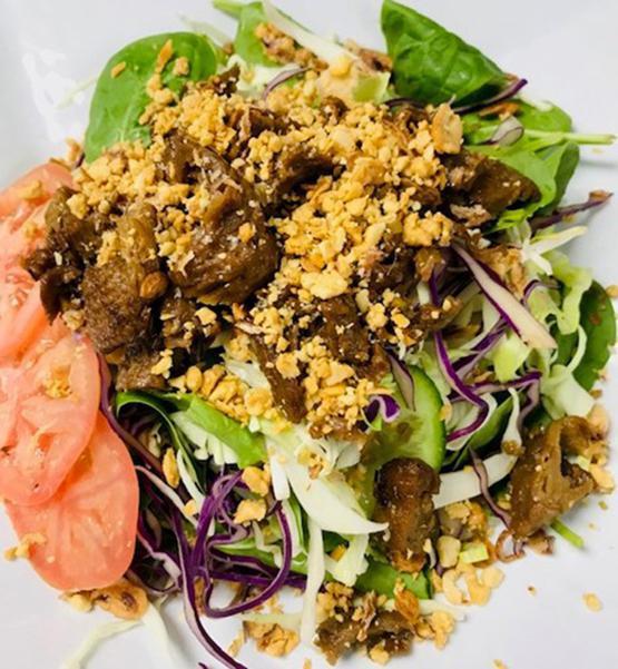 Fresh Mixed Green Salad · Vegan. Fresh mixed greens beansprout, shredded carrots, cilantro, cucumber, iceberg lettuce, mints, shredded cabbages, spinach, tomatoes, choice of meat, fried onion, crushed peanut, and a choice of dressing.