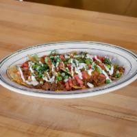 Traveling Nachos · Mini nachos served with ground beef, lettuce tomatoes, onions and sour cream.