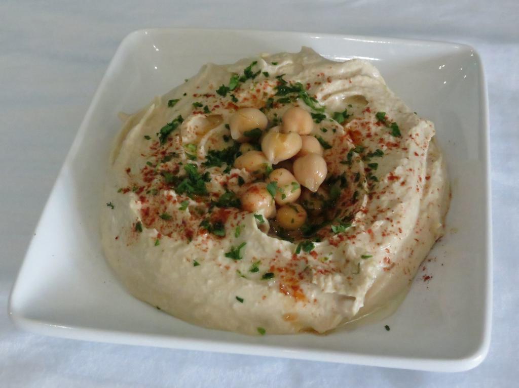 Hummus (V&GF) · Cooked chickpeas, mixed with tahini sauce, lemon juice and spices, served with 1 pita bread.