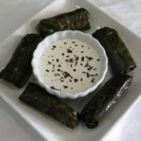 Grape Leaves (Dolmas) (V) · 6 grape leaves stuffed with rice, parsley and onion, served with tzatziki sauce.