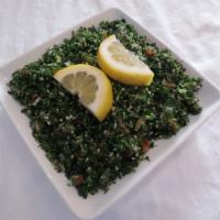 Tabbouleh Salad (V) · A mix of chopped parsley, tomato, onion, bulgar, spices, herbs, lemon juice and olive oil.