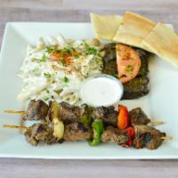 E6. Shish Kebab · Tender pieces of sirloin, marinated and grilled over an open flame,  served with any 2 sides...