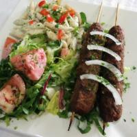 E7. Kofta Kebab · Ground beef kebab seasoned with parsley, onion and our house spice blend, grilled over an op...