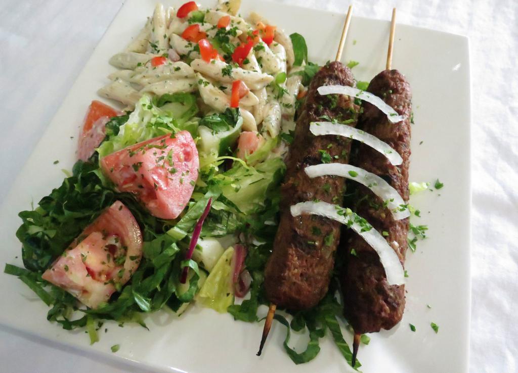 E7. Kofta Kebab · Ground beef kebab seasoned with parsley, onion and our house spice blend, grilled over an open fire, served with any 2 sides of your choice, pita bread and tzatziki sauce.
