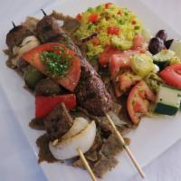 E8. Combination Feast · 1 shish kebab, 1 kofta kebab and a serving of gyro meat, served with any 2 sides of your cho...