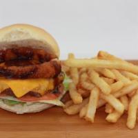 Western BBQ Burger · Made with 1/3 lb. Angus beef patty, cheddar cheese, onion rings and BBQ sauce, lettuce, toma...
