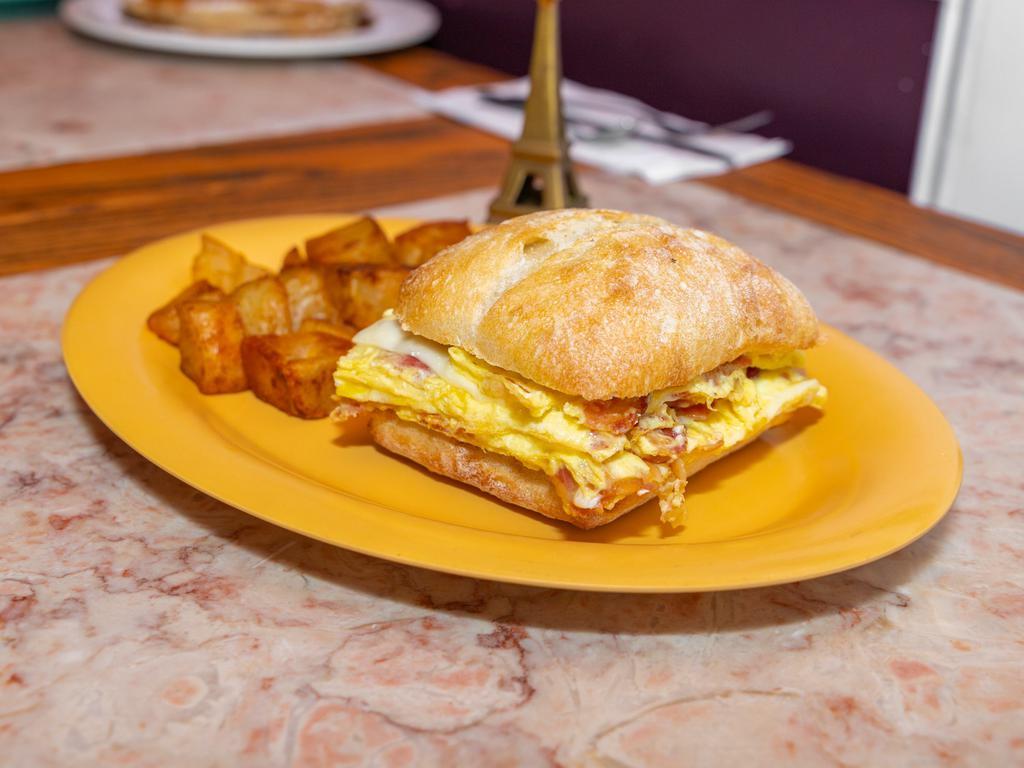 Breakfast Omelet Sandwich · Egg and cheese omelet with choice of bacon, ham, or sausage served on choice of bagel, breakfast roll, or croissant.