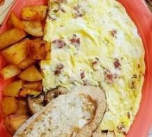 Luba's Pastrami Omelet · 3 egg omelet filled with pastrami and Swiss cheese served with home fries and toast.