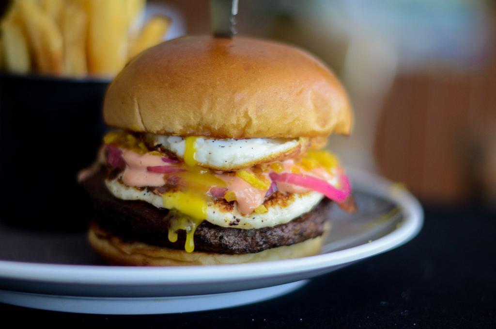 ¡Ay Dios Mio! Burger · Roasted panela cheese, criolla sauce, plantain panko, pickled onions and fried egg.