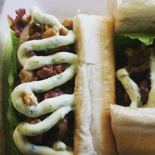 Tripleta · Puerto Rican street food style 3 meats sandwich, sharp provolone, grilled onions, chimichurri aioli, lettuce and tomatoes.