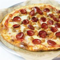 Mega Meat Pizza · Meatatarians, rejoice!  Dig into the tender Meatball, Sausage and Pepperoni trio on top of h...