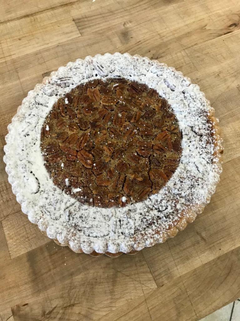 Pecan Pie · The perfect combination of cookie and candy. Shortbread crust with chewy caramel, roasted pecans, and a chocolate drizzle.