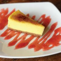 Crème Brûlée Cheesecake · A perfect blend of two classic desserts served with our house made Strawberry Sauce.