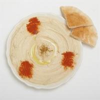 Hummus · A blend of mashed chickpeas, tahini, olive oil, and spices. Served as cold dips pita bread.
