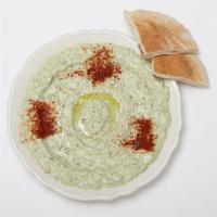 Baba Ghannouj · Mashed grilled eggplant blended with yogurt, tahini, parsley, and olive oil. Served as a col...