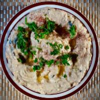 Baba Ghanouj · Mashed cooked eggplant, olive oil, lemon juice, various seasonings and tahini. Serve With Pi...