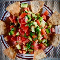 Mediterranean Salad · Tossed tomatoes, cucumbers, onions, parsley, topped with olive oil and lemon. Served with po...