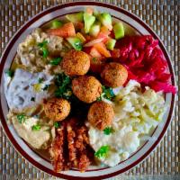 Mazza Platter · Hummus, tabouli, falafel, Mediterranean salad, Turkish salad, tahini and more. Served with p...