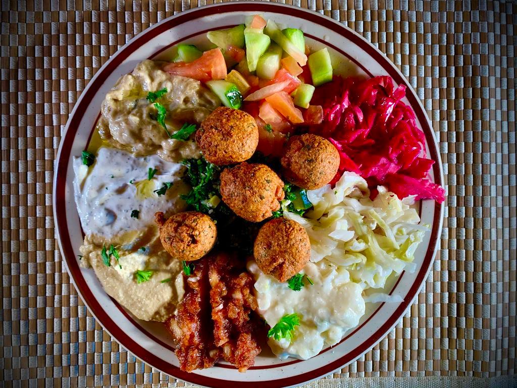 Mazza Platter · Hummus, tabouli, falafel, Mediterranean salad, Turkish salad, tahini and more. Served with pocket pita bread. Vegetarian.