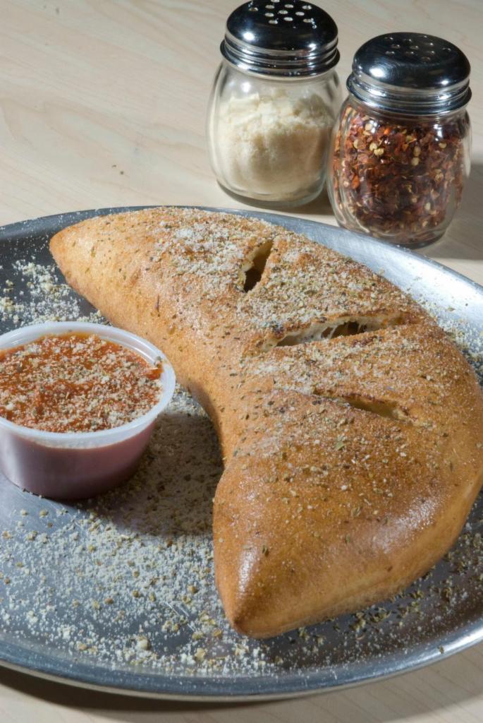 Custom Calzone · Pick any three toppings of your choice. Baked with mozzarella and ricotta cheeses and served with a side warm original marinara.