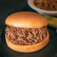 Smoked Chopped Brisket Sandwich · Includes 1 side of your choice plus pickles, peppers, red onions and bbq sauce.