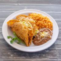 Tacos Dorados · 2 hard shell tacos with chicken or shredded beef.