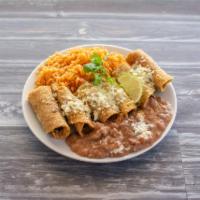 Taquitos Dorados · 3 rolled taquitos with chicken or shredded beef.
