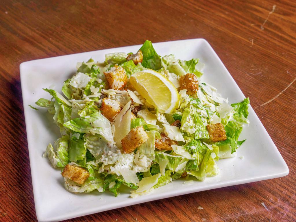 Caesar Salad · hearts of romaine, Caesar dressing, croutons & shaved  Parmesan cheese.