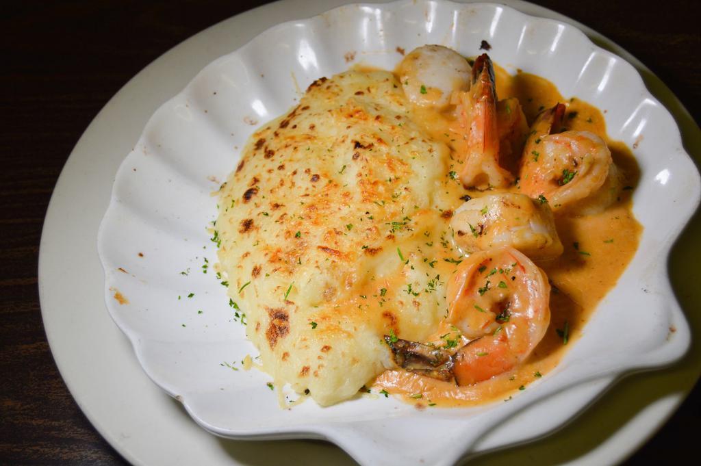 Coquille St Jacques · Shrimp and scallops in mustard cream sauce over mashed potatoes.