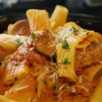 Greek Town Pasta · Rigatoni pasta with sliced sausage and feta cheese, served with spicy vodka sauce and homema...
