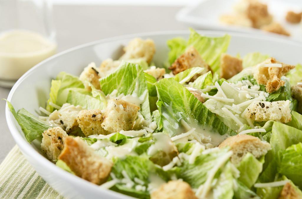 Caesar Salad · Romaine lettuce, homemade croutons, and parmesan cheese served with creamy Caesar dressing.