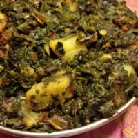 8. Saag Alu · Potatoes smothered in freshly ground spinach.