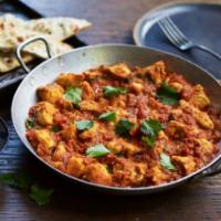 7. Chicken Madras · Chicken cubes cooked with fresh tomatoes, garlic and house blended medium spicy sauce. Serve...